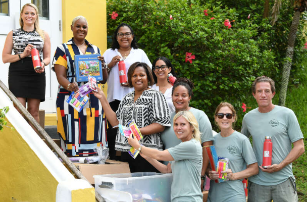 Helping hands: Support Public Schools and Ariel Re teamed up to provide essential school supplies to Victor Scott Primary School. Pictured from left are Sarah Morgan, principal Kennlyn Smith, Sacha Butterfield, Shawnette Griffin, Caroline Medeiros, Deanne Hart, Juliana Snelling, Nicolle O'Keefe and Magnus Henagulph (Photograph by Akil Simmons)